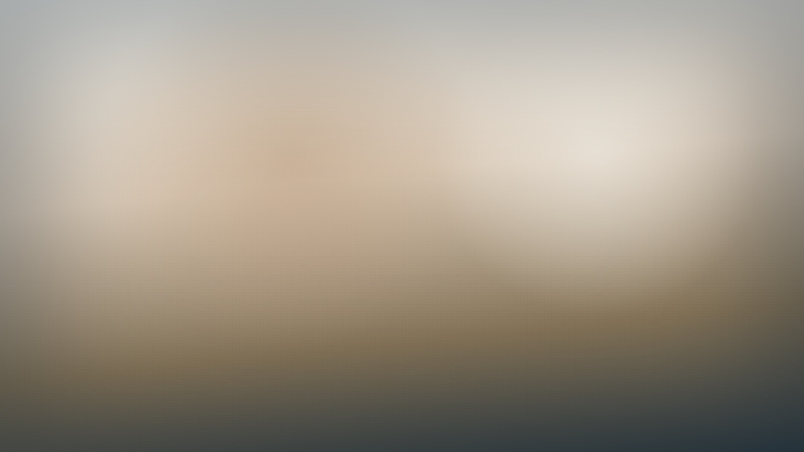 A broad expanse of soft, even colour beneath a still and quiet sky.